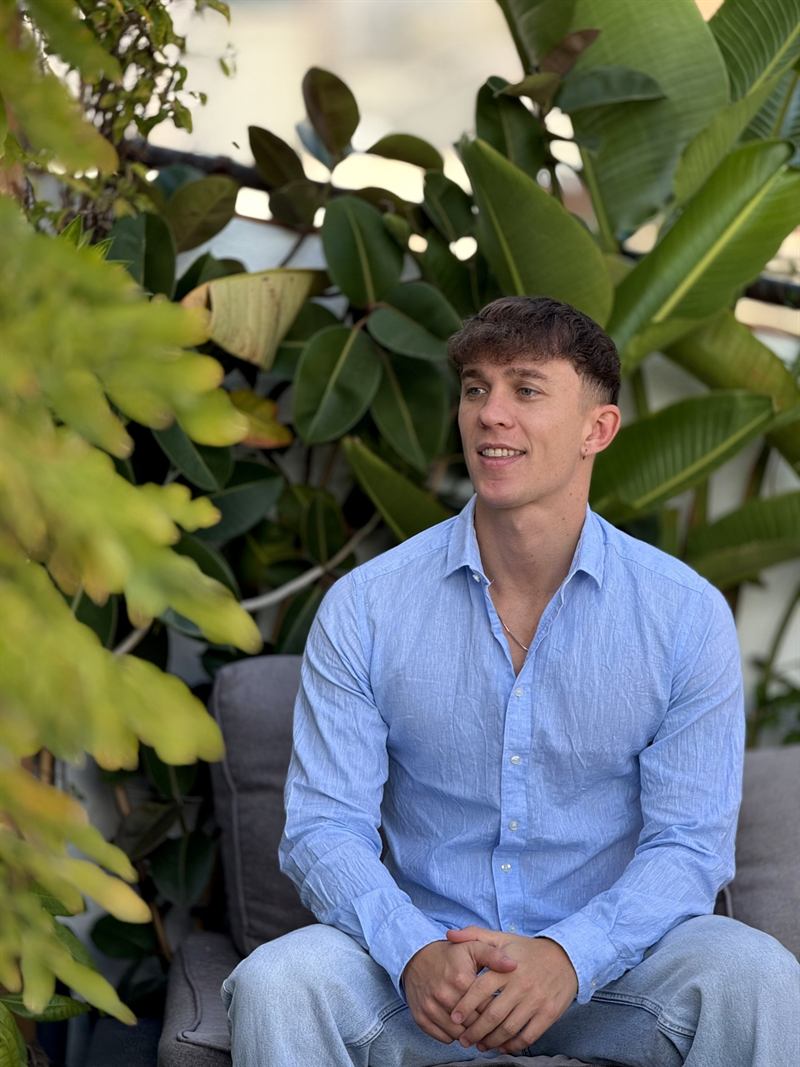 Dean Slidel, Managing Director of Landic, seated among plants