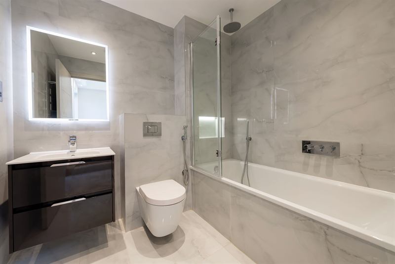 Bathroom with freestanding vanity and glass screen