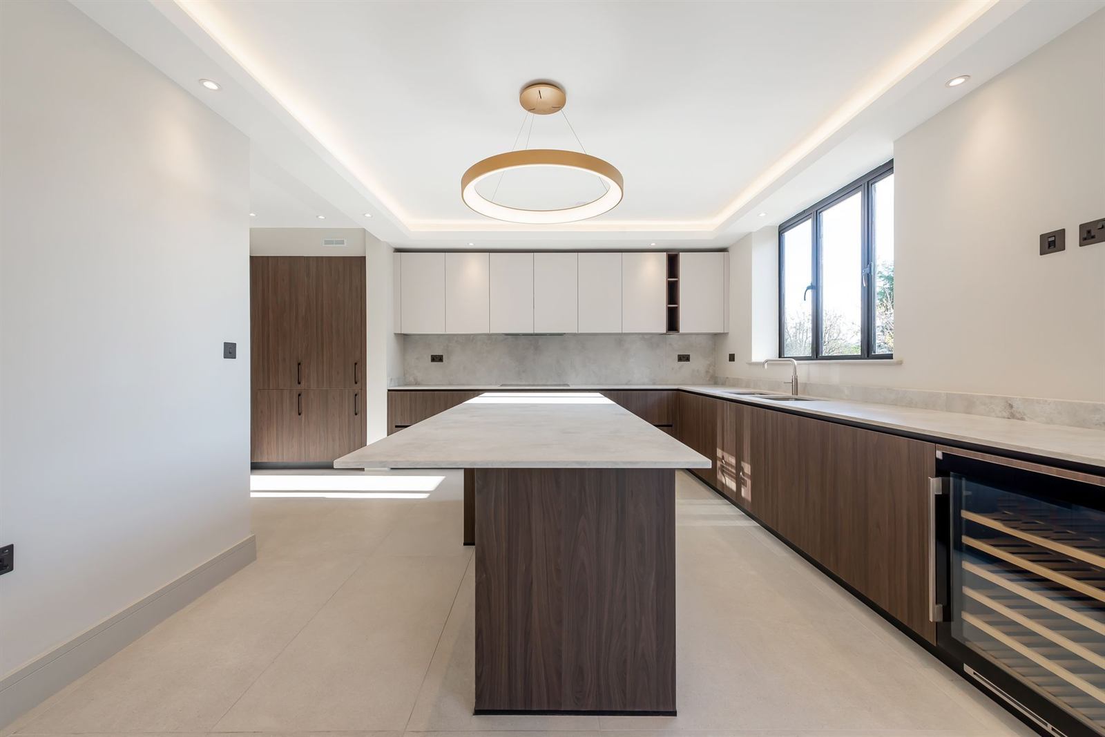 Completed open-plan kitchen with island and marble worktops