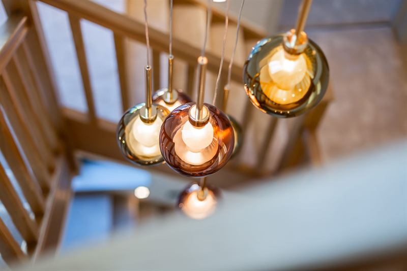 Amber glass pendant lights above a timber staircase
